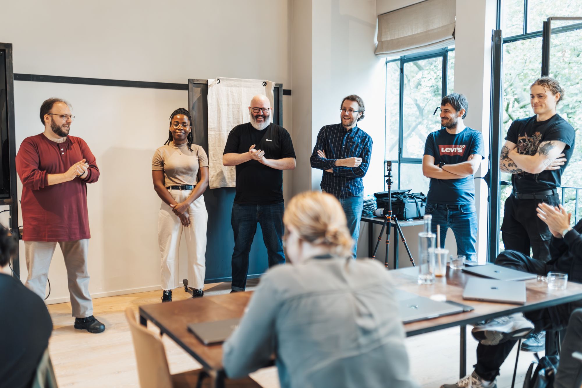 A practice team gathered for a brief morning huddle