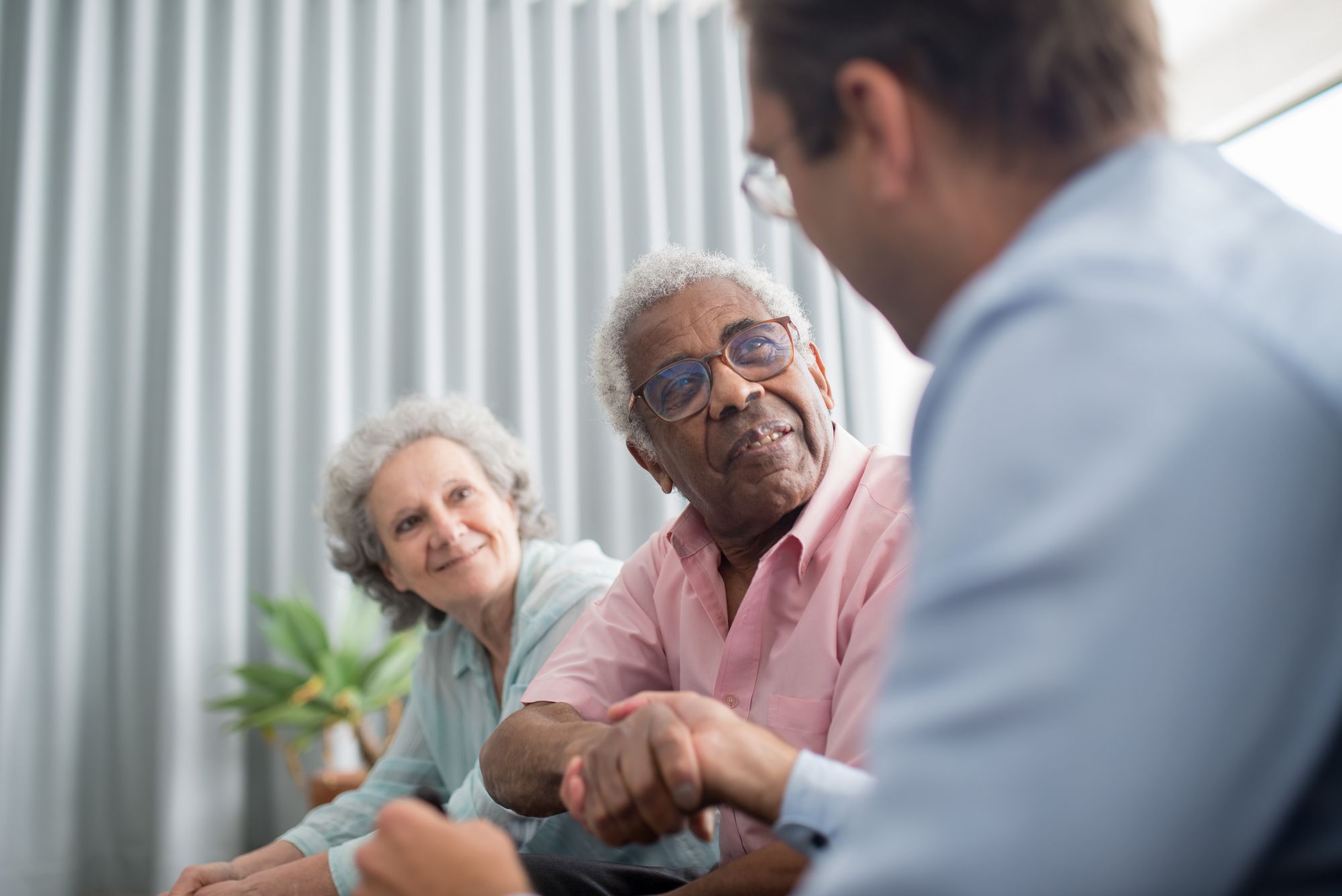 A clinician having a thoughtful advance care planning conversation with a patient and their partner