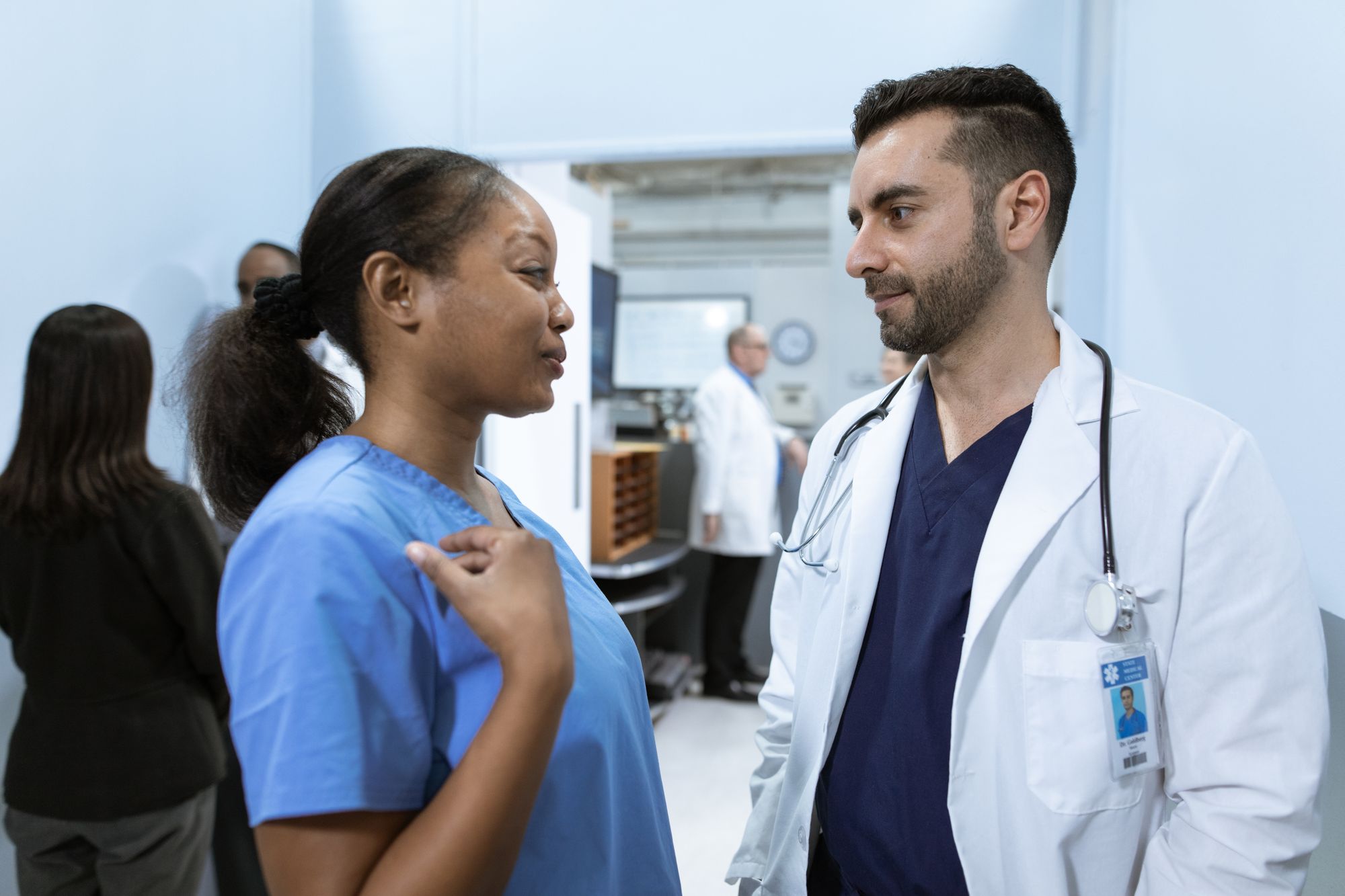Two clinicians discussing a case together inside a clinic