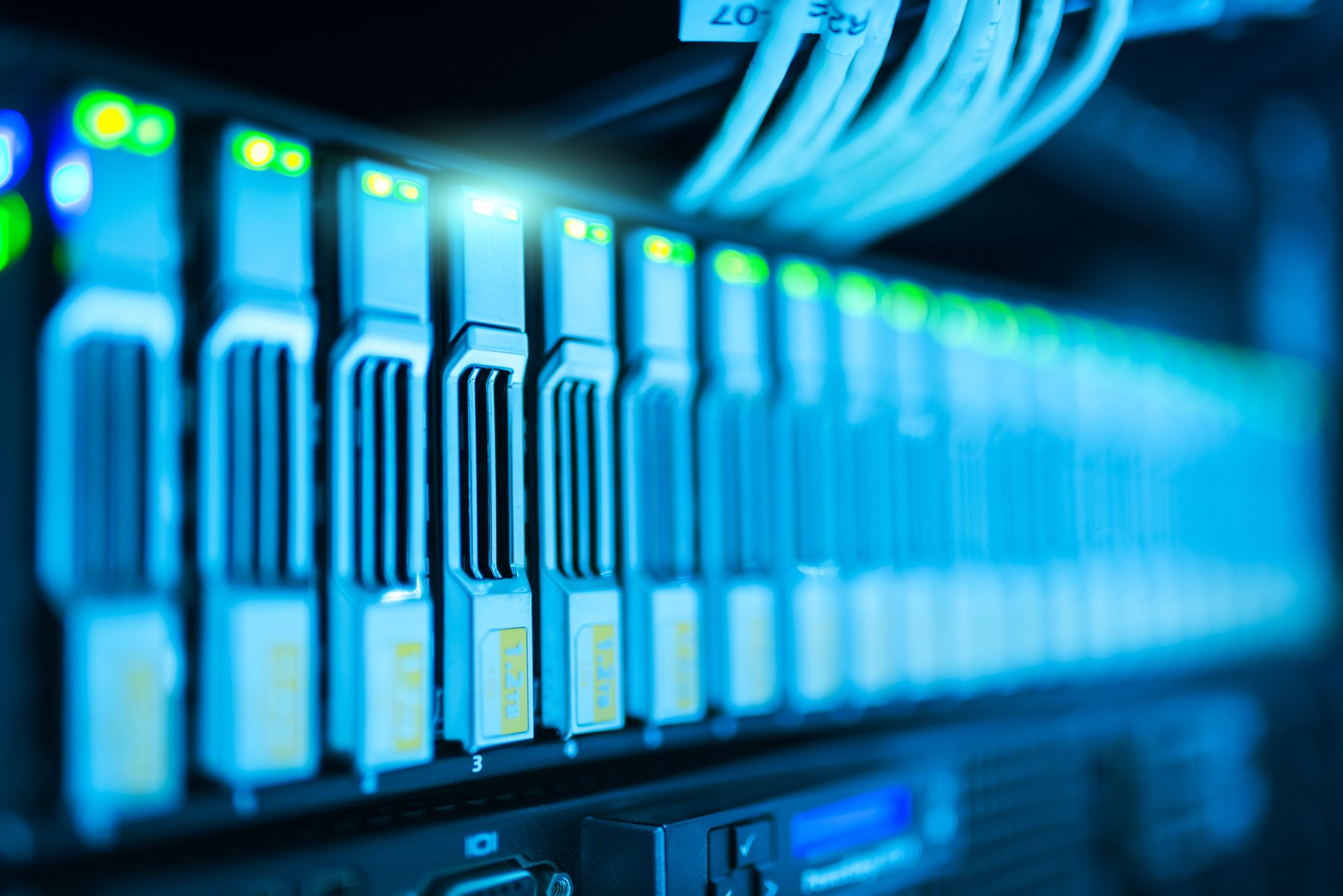 Rows of servers with blue indicator lights in a data center