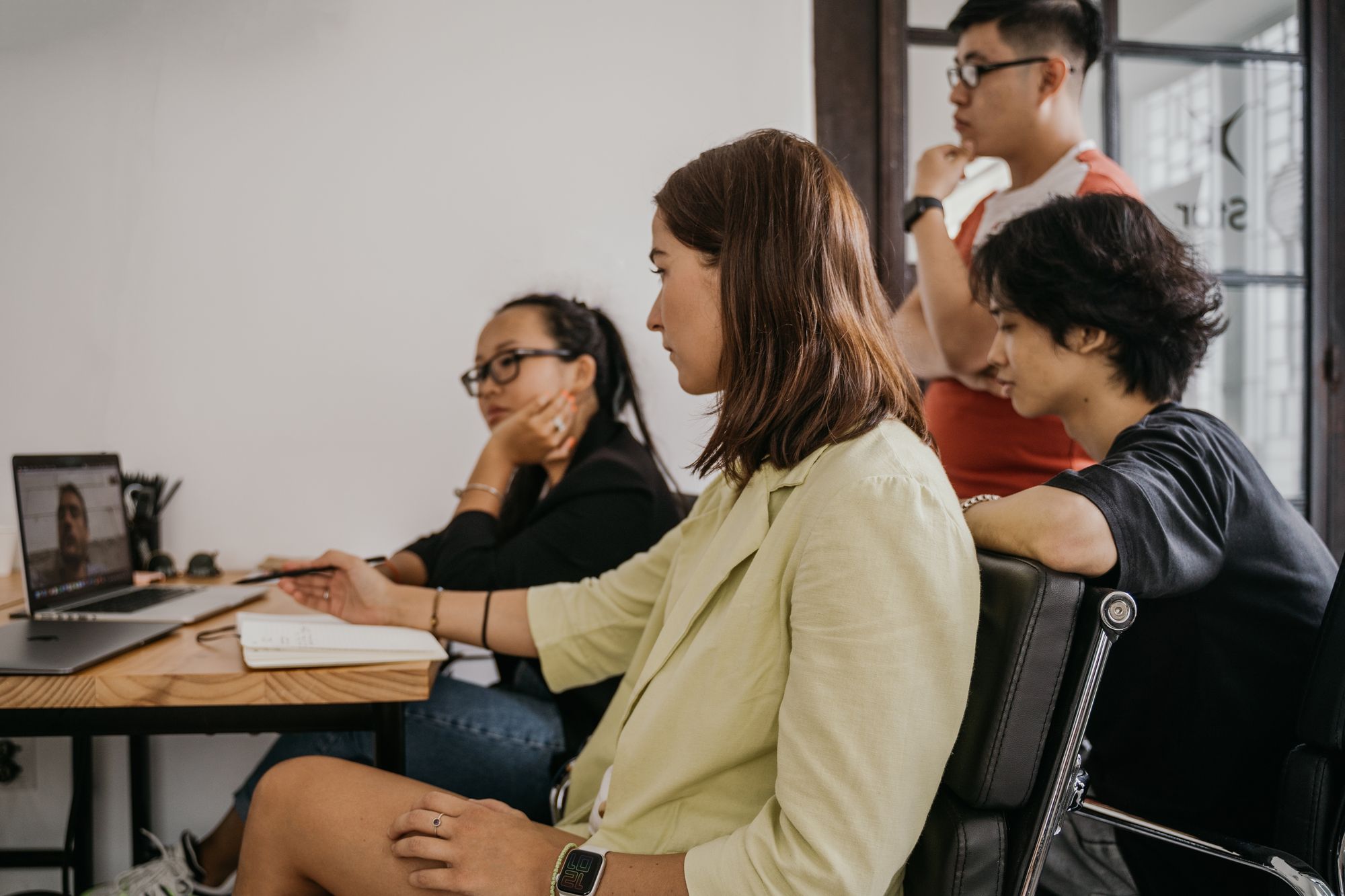 A practice manager coordinating on-site and remote staff on a video call