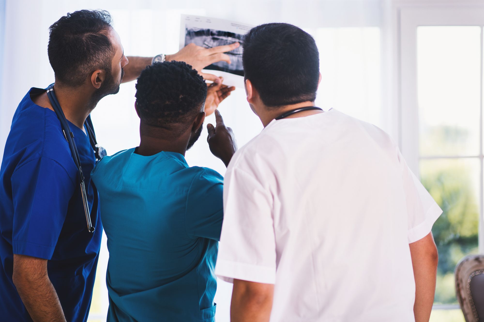 Clinicians examining an X-ray together