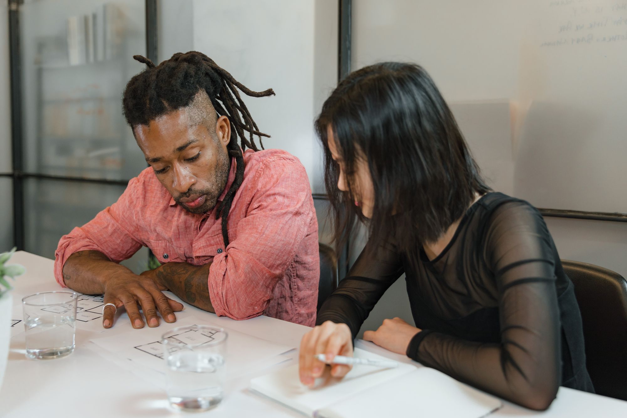 Two colleagues working through a medical office floor plan