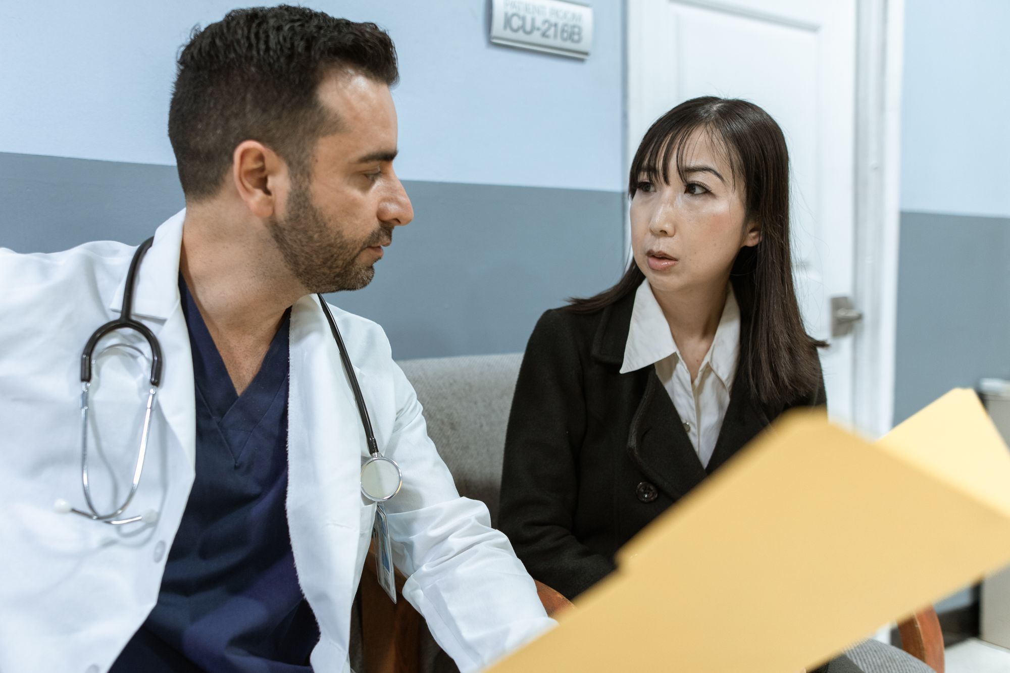Two clinicians reviewing written documents together