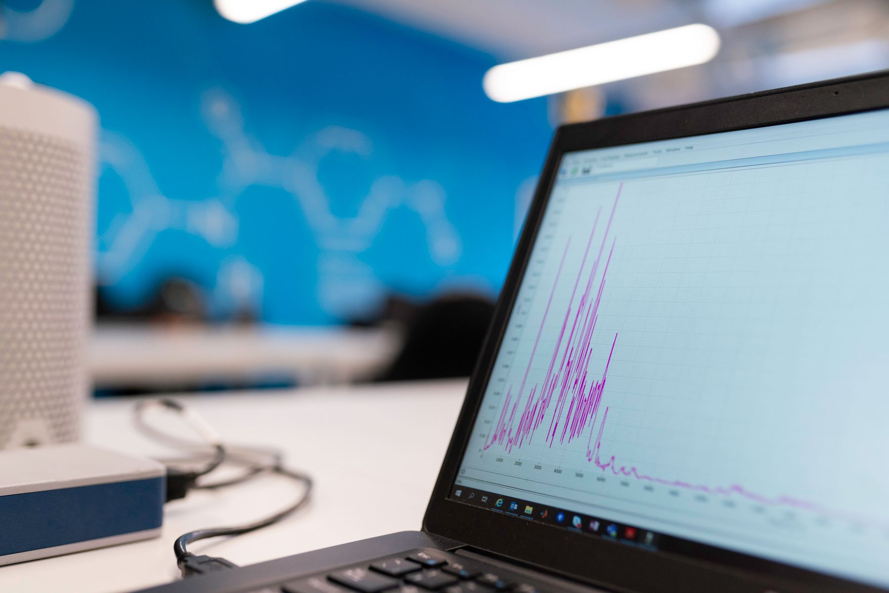 A laptop displaying a performance chart on an office desk
