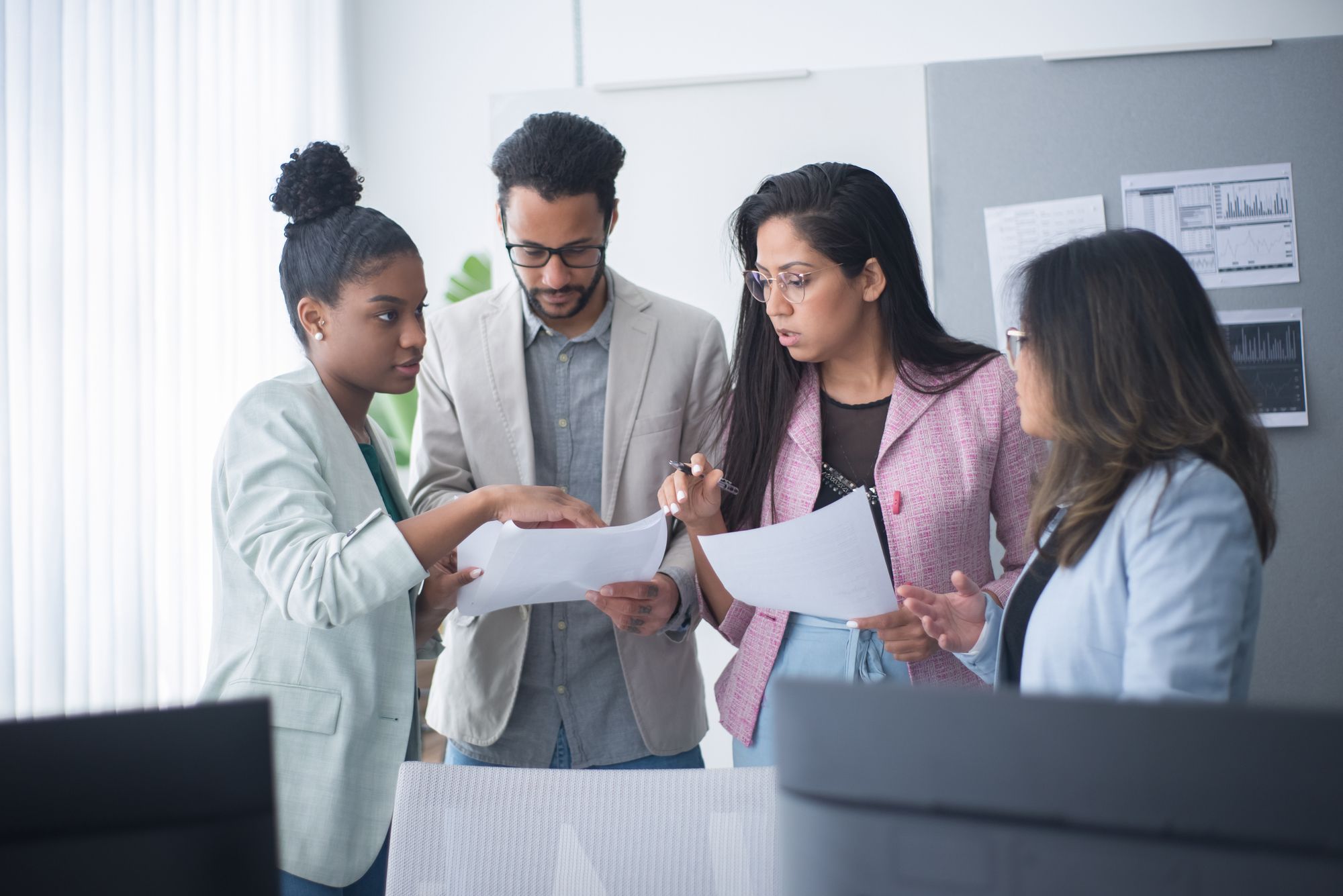 A practice team reviewing printed documents together in an office