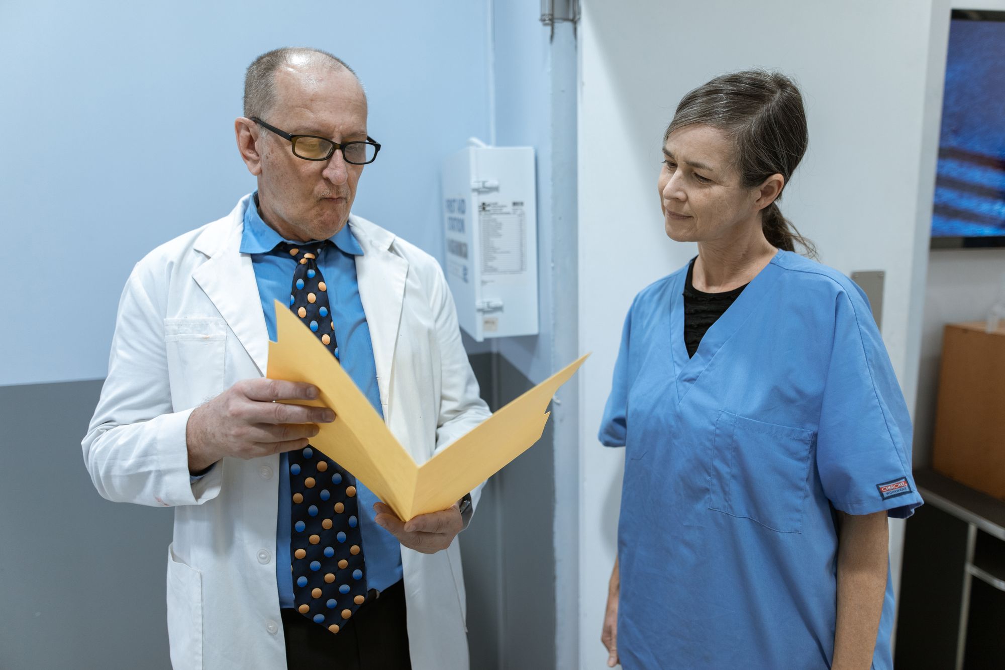Clinicians and nurses consulting together over patient records